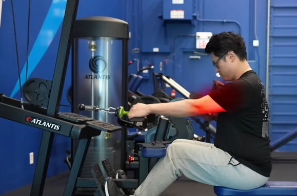 Cable row with arms-only pulling — red blur shows the forearms doing all the work, back disengaged